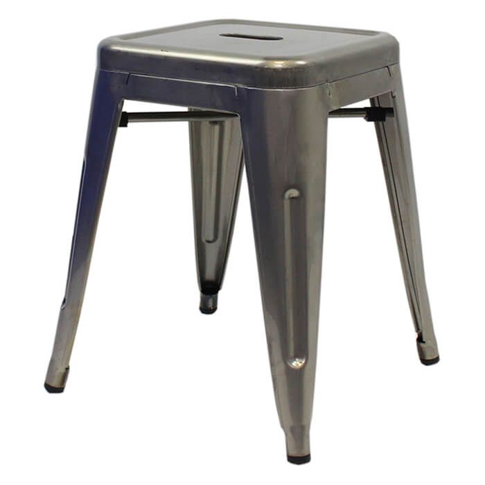 Profile view of industrial grey Tolix low stool