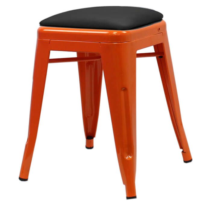 Profile view of orange Tolix low stool with dome seat