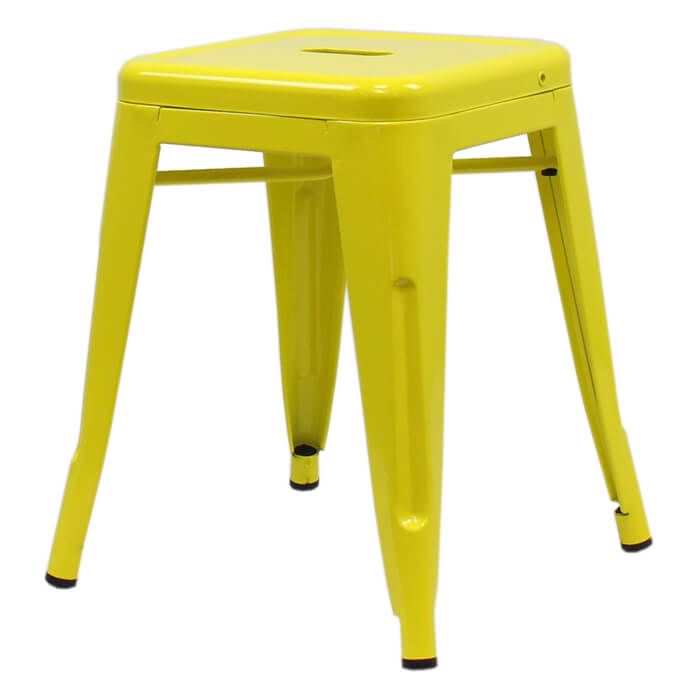 Profile view of yellow Tolix low stool
