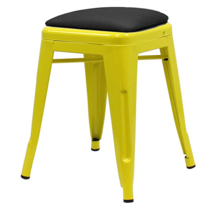 Profile view of yellow Tolix low stool with dome seat