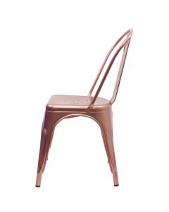 Profile view of rose gold Tolix side chair